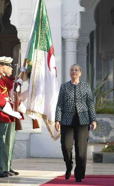 U.S. Secretary of State Hillary Clinton inspects an honour guard during a welcoming ceremony at the presidential palace in Algiers