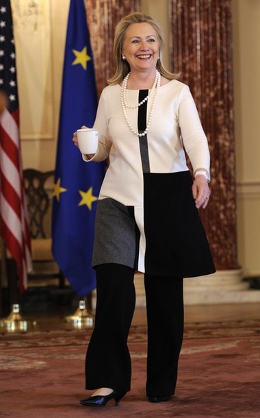 US Secretary of State Hillary Clinton carries a cup as she arrives to discuss the just-concluded G-8 Foreign Ministers Meeting, at the State Dept. in Washington