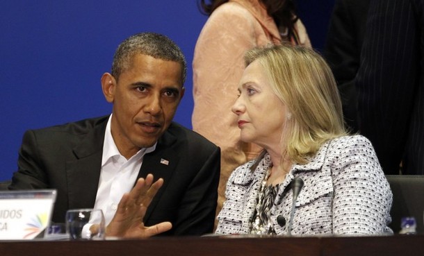 U.S. President Barack Obama and Secretary of State Hillary Clinton talk during the plenary session of the Summit of the Americas in Cartagena
