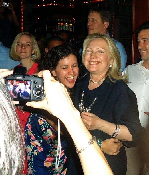 U.S. Secretary of State Hillary Clinton dances with members of her delegation in the Cafe Havana salsa bar, during a break from the Americas Summit in Cartagena