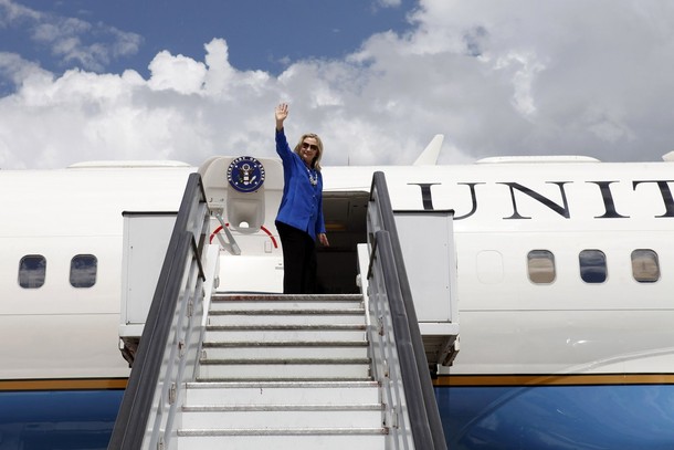 U.S. Secretary of State Hillary Clinton, en route to Brussels, waves goodbye in Brasilia