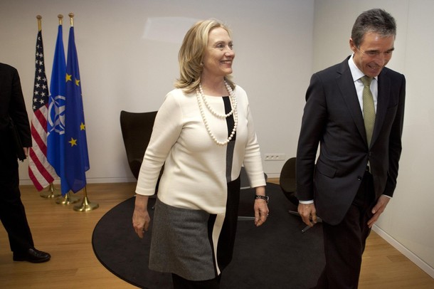 U.S. Secretary of State Hillary Clinton walks with NATO Secretary General Anders Fogh Rasmussen for a meeting at the NATO headquarters in Brussels