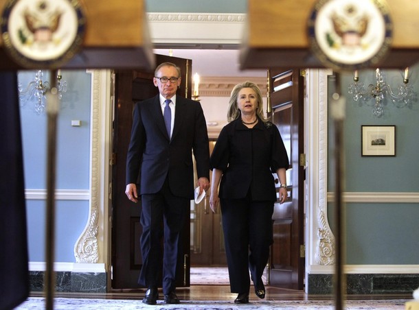 U.S. Secretary of State Hillary Clinton walks with Australian Foreign Minister Bob Carr after their meeting at the State Department in Washington