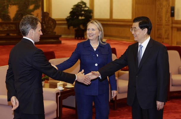 U.S. Secretary of State Hillary Clinton (C) looks on as China's President Hu Jintao (R) shakes hands with U.S. Treasury Secretary Timothy Geithner during a meeting at the Great Hall of the People in Beijing, May 4, 2012. REUTERS/Jason Lee (CHINA - Tags: POLITICS)