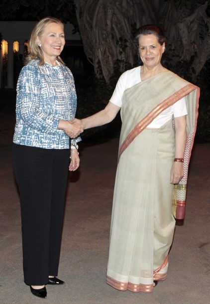 Chief of India's ruling Congress party Sonia Gandhi (R) and U.S. Secretary of State Hillary Clinton shake hands before their meeting in New Delhi May 7, 2012. Clinton leaned harder on India on Monday to deepen cuts of Iranian oil imports, saying Washington may not make a decision on whether to exempt New Delhi from financial sanctions for another two months. REUTERS/Adnan Abidi (INDIA - Tags: POLITICS)