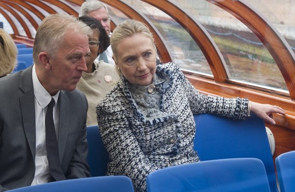 Denmark's Foreign Minister Villy Sovndal (L) speaks with U.S. Secretary of State Hillary Clinton as they take a boat tour down a canal through central Copenhagen May 31, 2012. REUTERS/Saul Loeb/Pool  (DENMARK - Tags: POLITICS)