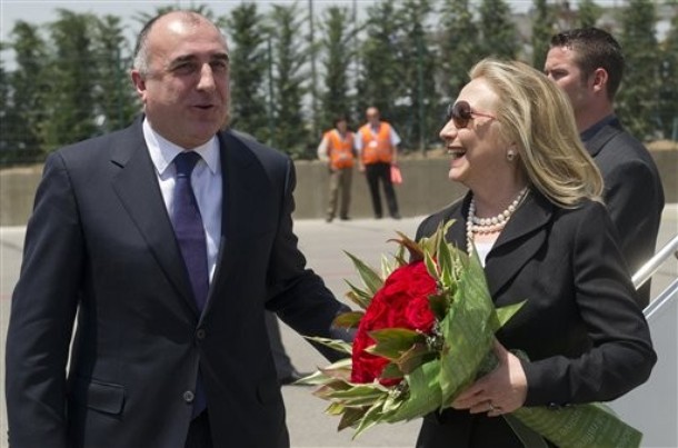 Azeri Foreign Minister Elmar Mammadyarov, left, greets US Secretary of State Hillary Rodham Clinton Wednesday June 6, 2012 upon her arrival the Heydar Aliyev International Airport in Baku, Azerbaijan.  Clinton has embarked on a tour of the South Caucasus in the hope of mediating progress in territorial disputes in the region.       (AP Photo/Saul Loeb, Pool)