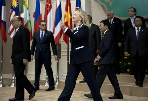 U.S. Secretary of State Hillary Rodham Clinton walks to her seat with other foreign ministers during an East Asia Summit Ministerial Meeting at the Association of Southeast Asian Nations regional forum at Peace Palace, Thursday, July 12, 2012, in Phnom Penh, Cambodia.   (AP Photo/Brendan Smialowski, Pool)