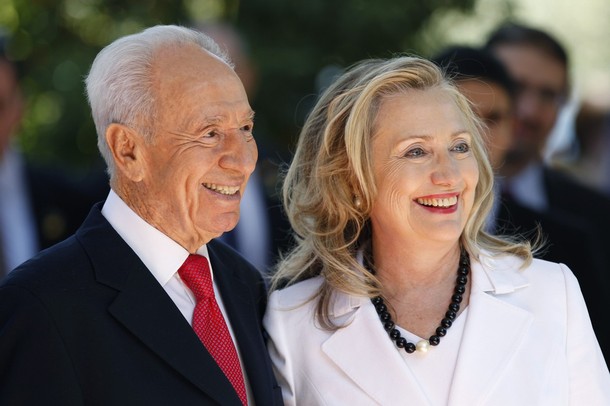 Israel's President Peres stands with U.S. Secretary of State Clinton before their meeting in Jerusalem