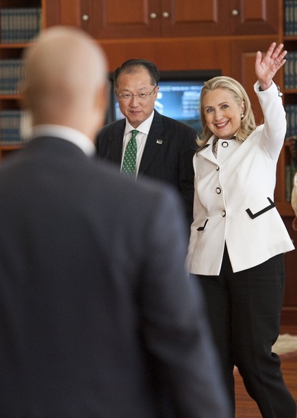 Secretary of State HIllary Rodham Clinton waves as she and World Bank President Jim Yong Kim, left, leave the Gallup headquarters after addressing the "Evidence and Impact: Closing the Gender Data Gap" conference in Washington, Thursday, July 19, 2012. (AP Photo/Cliff Owen)