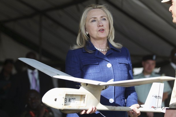 U.S. Secretary of State Hillary Clinton holds one of the 12 Raven unmanned aircrafts provided by the United States during her visit to Kasenyi Special Forces Group barracks south west of capital Kampala