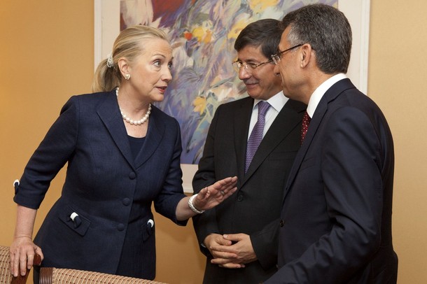 U.S. Secretary of State Clinton speaks to Turkey's Foreign Minister Davutoglu and Chairman of the AFAD Fuat Oktay after meeting with Syrian refugees in Istanbul