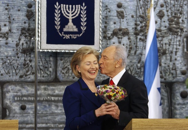 Israel's President Peres kisses U.S. Secretary of State Clinton after meeting in Jerusalem