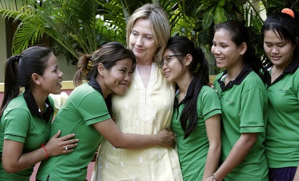 U.S. Secretary of State Hilary Clinton is greeted by human trafficking victims Van Sina and Somana at the Siem Reap AFESIP rehabilitation and vocational training center