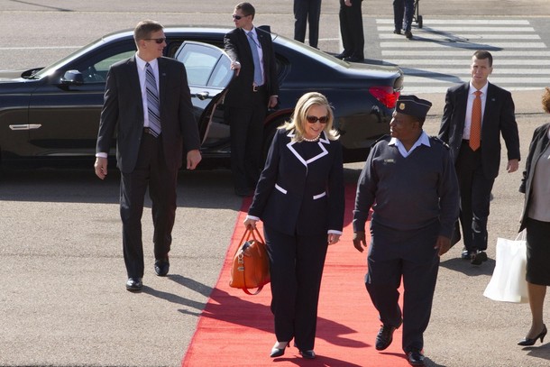 U.S. Secretary of State Hillary Clinton boards a plane to Qunu, for a private meeting with former South African President Nelson Mandela, at Waterkloof Air Base in Johannesburg