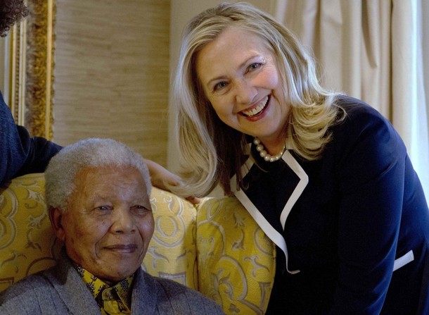 U.S. Secretary of State Hillary Rodham Clinton poses for a photograph with Nelson Mandela, former president of South Africa, at his home in Qunu