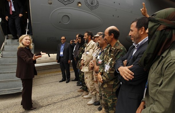 U.S. Secretary of State Clinton meets soldiers at the steps of her C-17 military transport upon her arrival in Tripoli