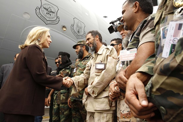 U.S. Secretary of State Clinton meets soldiers at the steps of her C-17 military transport upon her arrival in Tripoli