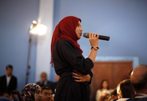 A Libyan student asks U.S. Secretary of State Hillary Clinton a question during a town hall meeting with the Youth and Civil Society at Tripoli University in Libya