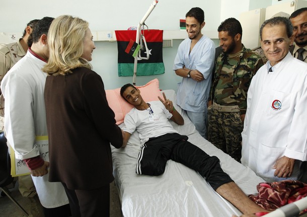 U.S. Secretary of State Hillary Clinton meets a wounded soldier at a Tripoli hospital during her visit to Libya