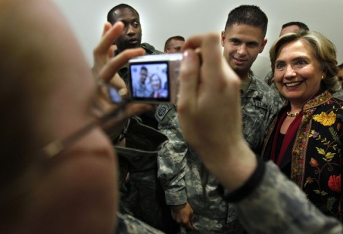 U.S. State Secretary Hillary Clinton poses for a picture with International troops at Kabul airport before he departure from Afghanistan