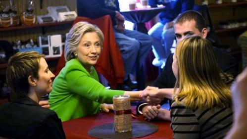 Former U.S. Secretary of State Clinton talks with local residents as she campaigns at the Jones Street Java House in LeClaire, Iowa