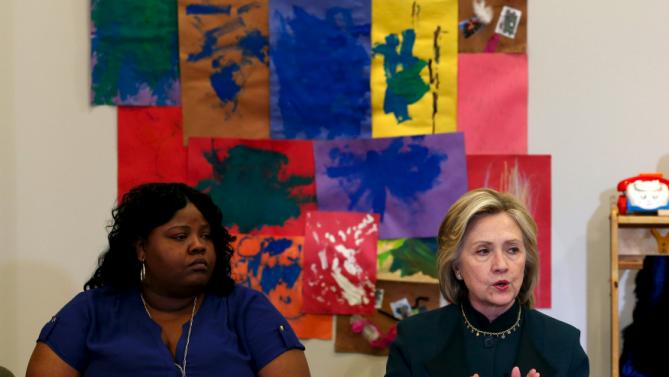 U.S. presidential candidate Hillary Clinton speaks at a roundtable discussion about childcare next to Lakesia Collins during a campaign stop in Chicago, Illinois, United States, May 20, 2015.    REUTERS/Jim Young