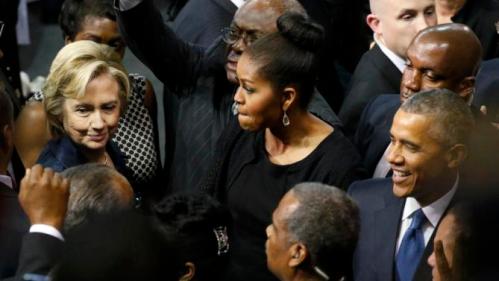 U.S. Democratic presidential candidate Hillary Clinton (L) talks with first lady Michelle Obama and President Barack Obama after the conclusion of funeral services for Rev. Clementa Pinckney in Charleston, South Carolina June 26, 2015. Pinckney was one of nine victims of a mass shooting at the Emanuel African Methodist Episcopal Church. REUTERS/Jonathan Ernst