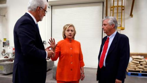 Democratic presidential candidate Hillary Rodham Clinton, center, speaks with Doug McCarron, president of the United Brotherhood of Carpenters and Joiners of America, left, and Bill Irwin Jr., Executive Director of the Carpenters International Training Center, right, while touring the Carpenters International Training Center Tuesday, Aug. 18, 2015, in Las Vegas. The training center was one of several places Clinton visited in the Las Vegas area on Tuesday. (AP Photo/John Locher)