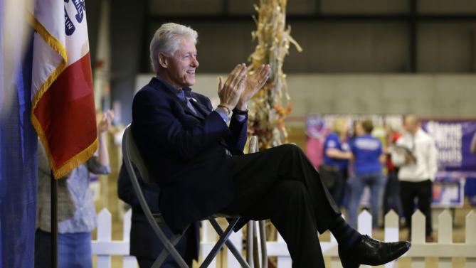 Former President Bill Clinton listens to his wife Democratic presidential candidate Hillary Rodham Clinton speak at the Central Iowa Democrats Fall Barbecue Sunday, Nov. 15, 2015, in Ames, Iowa. (AP Photo/Charlie Neibergall)