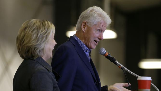 Democratic presidential candidate Hillary Rodham Clinton listens to her husband former President Bill Clinton speak at the Central Iowa Democrats Fall Barbecue Sunday, Nov. 15, 2015, in Ames, Iowa. (AP Photo/Charlie Neibergall)