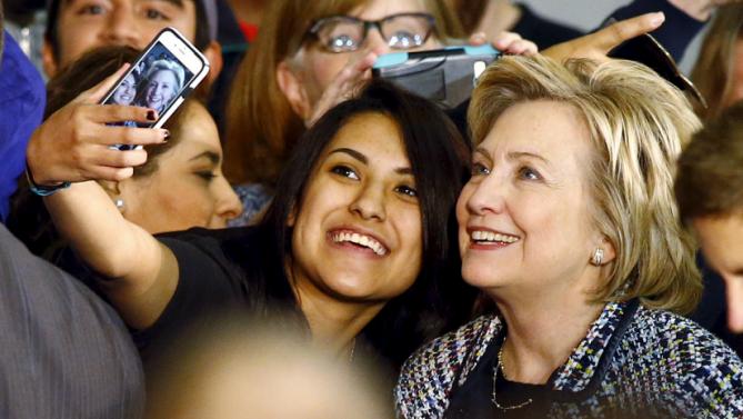 Democratic U.S. presidential candidate Hillary Clinton poses for a selfie with a supporter at a Grassroots Organizing Event at Mountain View College in Dallas, Texas, November 17, 2015. REUTERS/Mike Stone