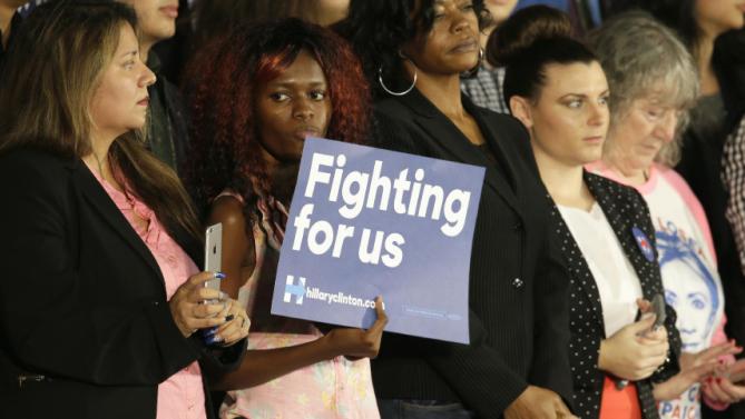 A supporter holds a sign for Democratic presidential candidate Hillary Rodham Clinton during a campaign event at Mountain View Community College, Tuesday, Nov. 17, 2015, in Dallas. (AP Photo/LM Otero)