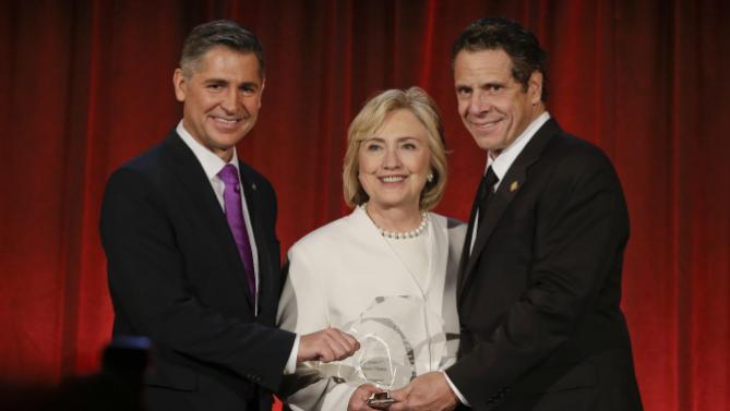 Brady Campaign President Dan Gross, left, and New York Gov. Andrew Cuomo, right, pose for photographs with Democratic presidential candidate Hillary Rodham Clinton before she at the Brady Bear Awards Gala Thursday, Nov. 19, 2015, in New York. (AP Photo/Frank Franklin II)