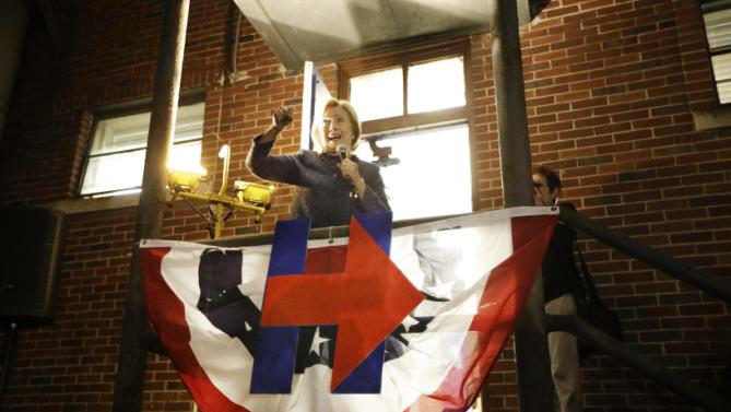 Democratic presidential candidate Hillary Rodham Clinton speaks from a gymnasium side porch to people who weren't able to fit in to hear her speech at Fisk University Friday, Nov. 20, 2015, in Nashville, Tenn. (AP Photo/Mark Humphrey)