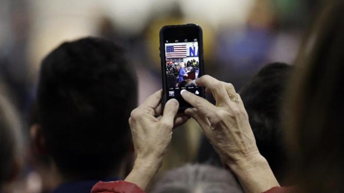 A woman takes a picture as Democratic presidential candidate Hillary Rodham Clinton speaks at Fisk University Friday, Nov. 20, 2015, in Nashville, Tenn. (AP Photo/Mark Humphrey)