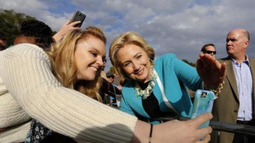 Democratic presidential candidate Hillary Rodham Clinton takes a photo with a supporter after her speech at the Jenkins Orphanage in North Charleston, S.C., Saturday, Nov. 21, 2015, during the Blue Jamboree event. (AP Photo/Mic Smith)