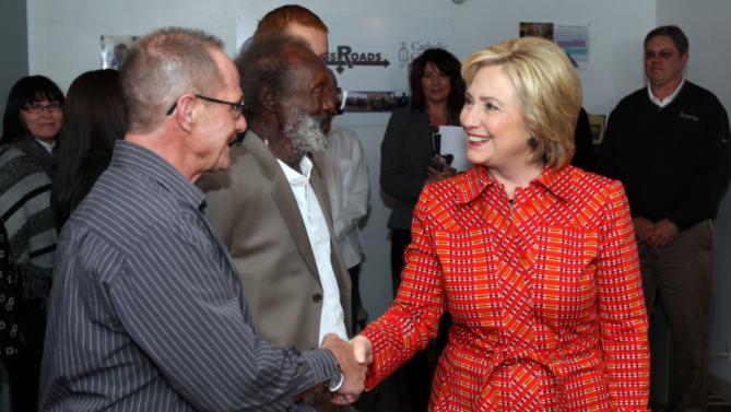 Democratic presidential candidate Hillary Rodham Clinton meets Mike McClean, a recovering alcoholic, during a tour of Crossroads an Substance Abuse Facility sponsored by Catholic Charities of Northern Nevada Monday, Nov. 23, 2015, in Reno, Nev. (AP Photo/Lance Iversen)