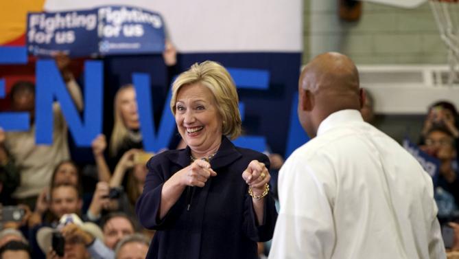 U.S. Democratic presidential candidate Hillary Clinton gestures at Denver mayor Michael Hancock who introduced her at a campaign event at a high school in Denver, Colorado November 24, 2015.   REUTERS/Rick Wilking