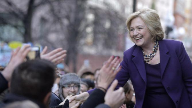 Democratic presidential candidate Hillary Clinton, right, greets people in a crowd before a rally at Faneuil Hall, Sunday, Nov. 29, 2015, in Boston. Clinton and Boston Mayor Marty Walsh attended the event held to launch "Hard Hats for Hillary," a coalition to organize working families in construction, building, transportation, and other labor industries to support Clinton's agenda. (AP Photo/Steven Senne)