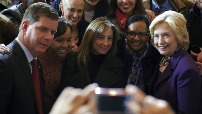 U.S. Democratic presidential candidate Hillary Clinton (R) and Boston Mayor Marty Walsh (L) pose for a photograph with audience members during a campaign rally with labor unions at Faneuil Hall in Boston, Massachusetts November 29, 2015. Walsh endorsed Clinton at the rally. REUTERS/Brian Snyder