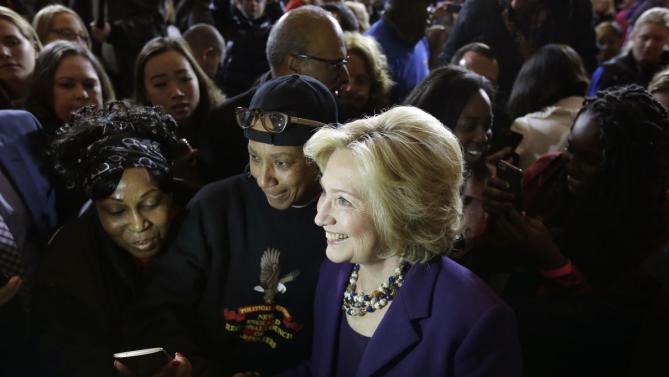 Democratic presidential candidate Hillary Clinton, center, stands with people in the crowd for a photograph at the conclusion of a rally at Faneuil Hall, Sunday, Nov. 29, 2015, in Boston. (AP Photo/Steven Senne)