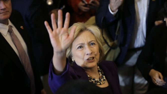 Democratic presidential candidate Hillary Clinton waves to people in a crowd at the conclusion of a rally at Faneuil Hall, Sunday, Nov. 29, 2015, in Boston. Clinton and Boston Mayor Marty Walsh attended the event held to launch “Hard Hats for Hillary," a coalition created to organize people in industries and labor to support Clinton's agenda. (AP Photo/Steven Senne)