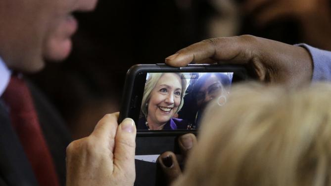 Democratic presidential candidate Hillary Clinton poses for a selfie while greeting people in the crowd at the conclusion of a rally at Faneuil Hall, Sunday, Nov. 29, 2015, in Boston. Clinton and Boston Mayor Marty Walsh, top left, attended the event held to launch “Hard Hats for Hillary," a coalition created to organize people in industries and labor to support Clinton's agenda. (AP Photo/Steven Senne)