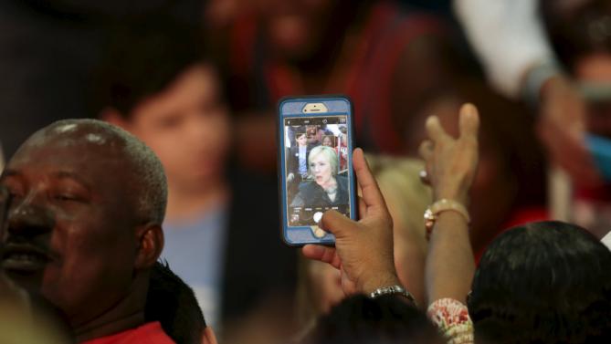 A supporter of U.S. Democratic presidential candidate Hillary Clinton captures a photo of Clinton at an election campaign event in Orlando, Florida December 2, 2015.  REUTERS/Scott Audette