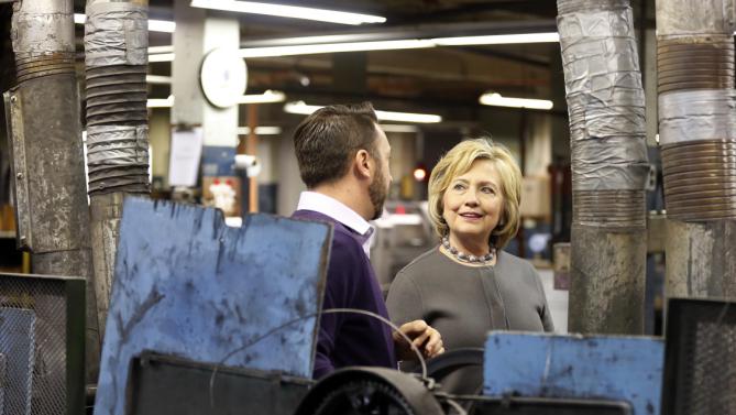 Democratic presidential candidate Hillary Clinton speaks to Arron Bagshaw during a tour and campaign stop at WH Bagshaw, a 5th generation family owned business Thursday, Dec. 3, 2015, in Nashua, N.H. (AP Photo/Jim Cole)