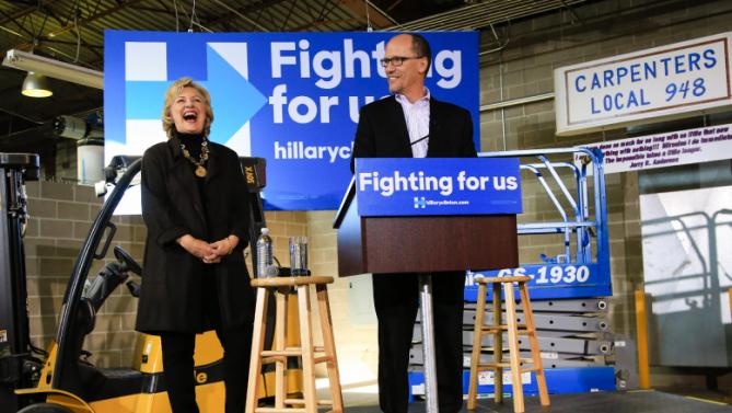 Democratic presidential candidate Hillary Clinton laughs as U.S. Secretary of Labor Tom Perez endorses her during a campaign stop in Sioux City, Iowa, Friday, Dec. 4, 2015. (AP Photo/Nati Harnik)