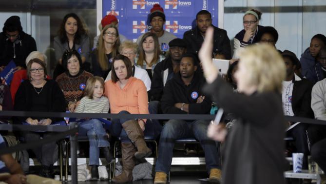 Supporters watch as Democratic presidential candidate Hillary Clinton speaks during a town hall meeting Friday, Dec. 4, 2015, in Fort Dodge, Iowa. (AP Photo/Charlie Neibergall)