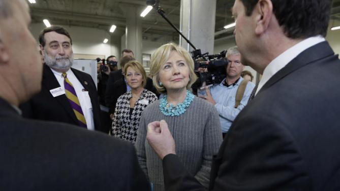 Democratic presidential candidate Hillary Clinton listens as she tours the Cedar Valley TechWorks, Wednesday, Dec. 9, 2015, in Waterloo, Iowa. (AP Photo/Charlie Neibergall)