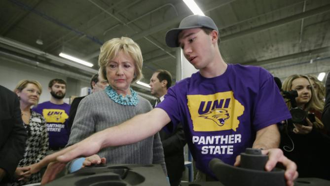 Democratic presidential candidate Hillary Clinton listens to Andrew Yersin, a junior at the University of Northern Iowa, as she tours the Cedar Valley TechWorks, Wednesday, Dec. 9, 2015, in Waterloo, Iowa. (AP Photo/Charlie Neibergall)